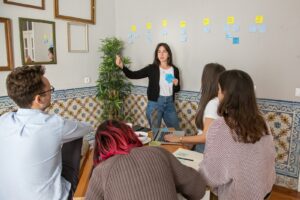 a group of people sitting around a wooden table